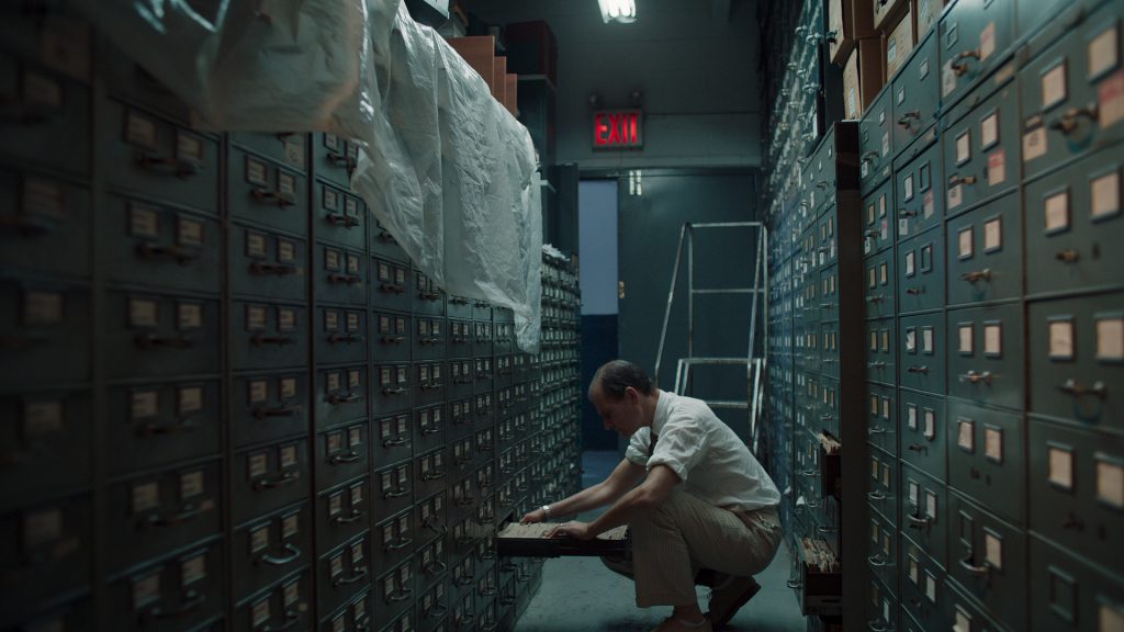 Man kneeling in the new york times morgue photo archive